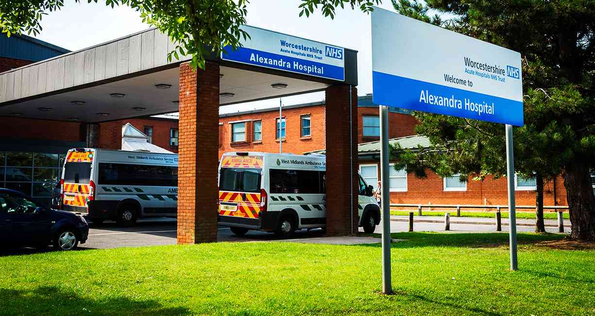 Alexandra Hospital entrance canopy with ambulances and NHS welcome sign, Woodrow Drive, Redditch