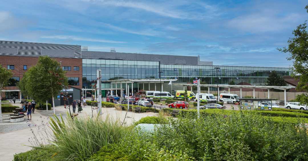 Royal Stoke University Hospital main building and Entrance 1 sign on Newcastle Road, Stoke-on-Trent